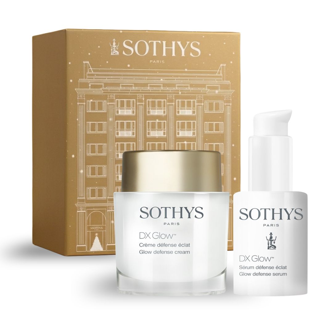 Coffret cosmétique Prévente - Coffret défense éclat, boîte dorée à motif architectural avec crème blanche et sérum en flacon pompe.
