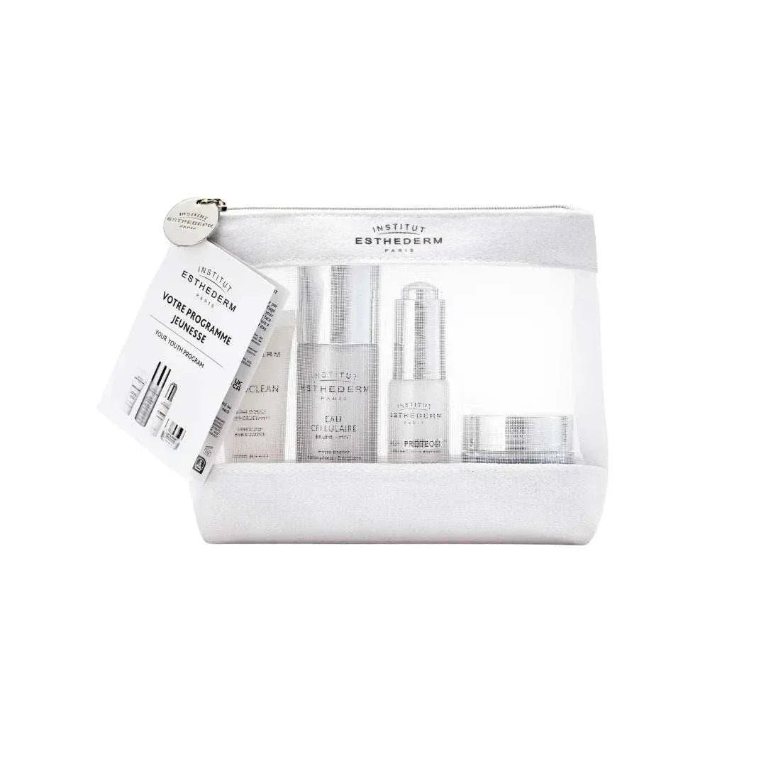 Esthederm youth program set with skincare products in a transparent pouch