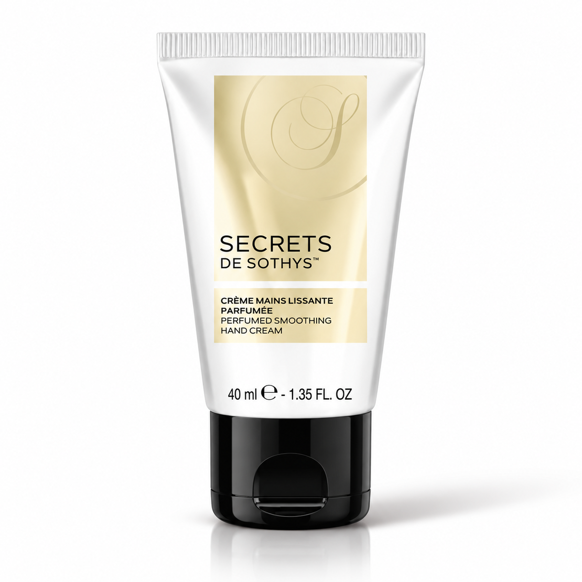 Crème mains Secrets lissante parfumée, en tube blanc et doré de 40 ml avec bouchon noir.
